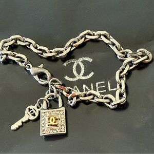 Silver and Gold Chain Bracelet with Key and Lock Charm from Chanel style.